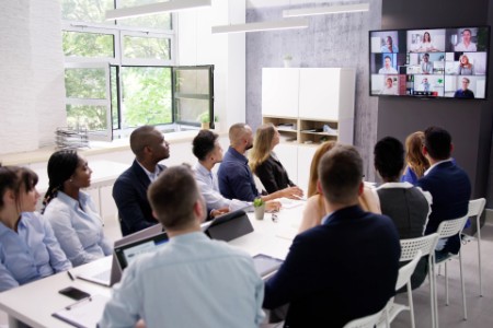 Hybrid team boardroom meeting